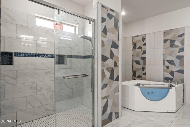 bathroom featuring washer / dryer and shower with separate bathtub