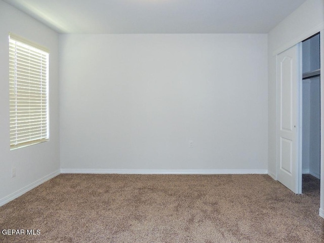 unfurnished bedroom with carpet flooring and a closet