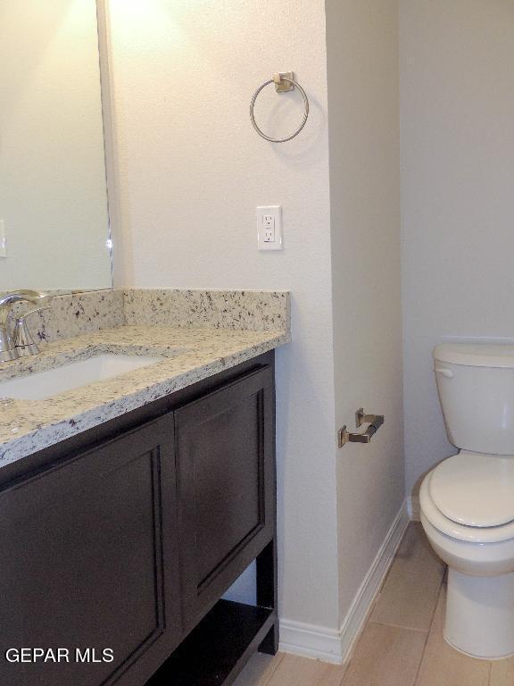 bathroom with tile patterned floors, vanity, and toilet