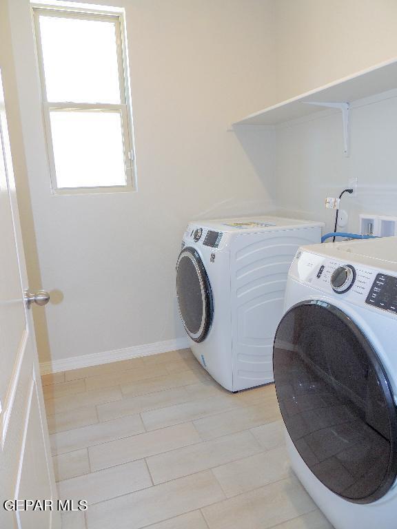 washroom featuring washing machine and dryer