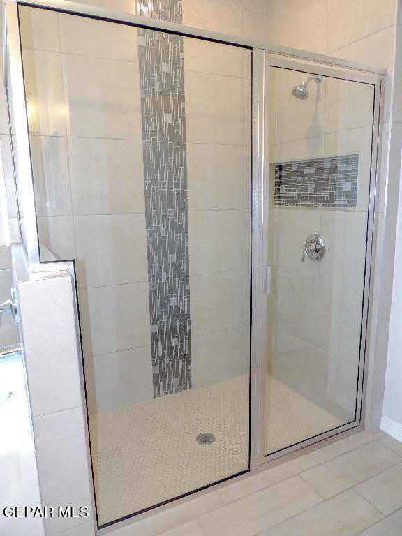 bathroom with a shower with shower door