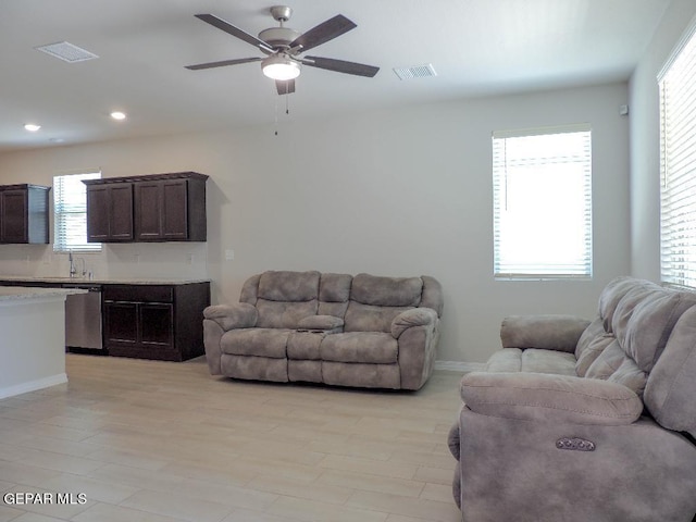 living room featuring light hardwood / wood-style floors and ceiling fan