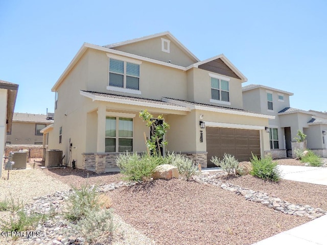 view of front of house featuring a garage and central air condition unit