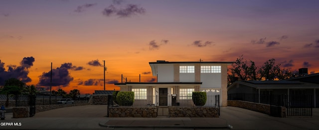 view of front of house featuring fence and driveway