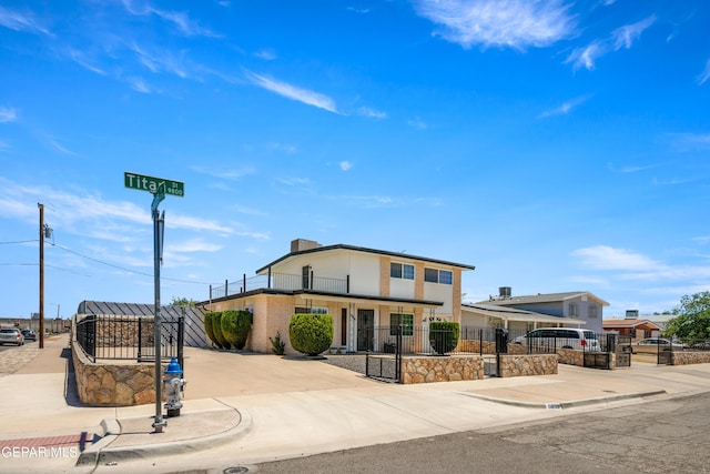 view of front of house featuring a fenced front yard and concrete driveway