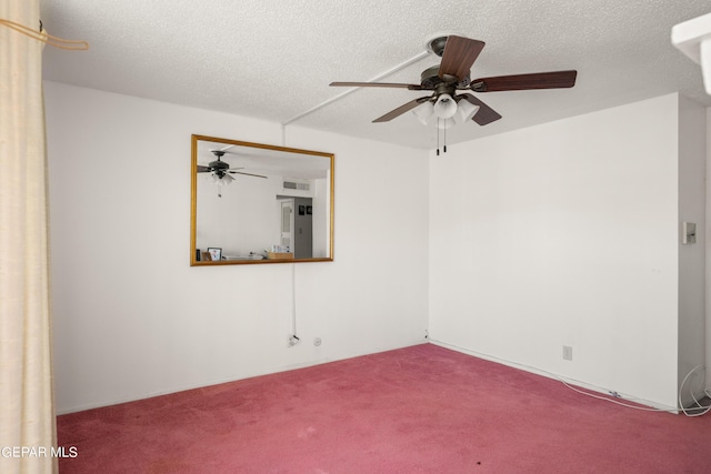 unfurnished room featuring carpet, visible vents, and a textured ceiling