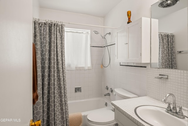 bathroom featuring shower / bath combination with curtain, tile walls, toilet, and vanity