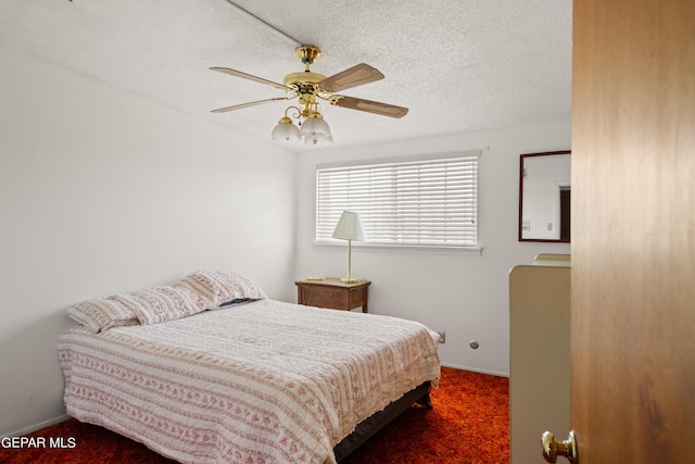 bedroom featuring a ceiling fan, a textured ceiling, baseboards, and carpet flooring