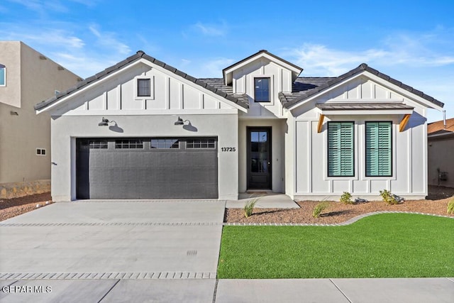 modern farmhouse featuring a front yard and a garage