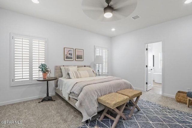 bedroom with ensuite bath, ceiling fan, and carpet