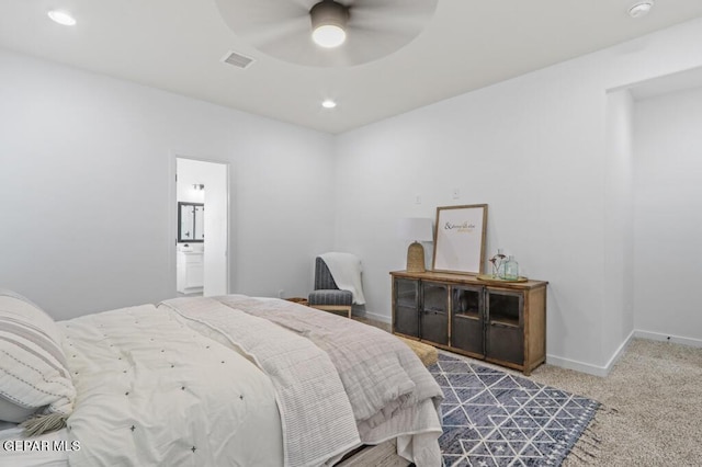 bedroom featuring carpet floors, ensuite bathroom, and ceiling fan