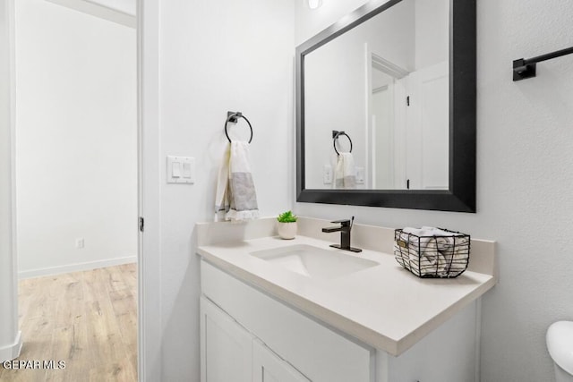 bathroom featuring hardwood / wood-style flooring and vanity