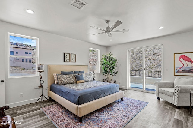 bedroom featuring hardwood / wood-style floors, ceiling fan, and access to outside