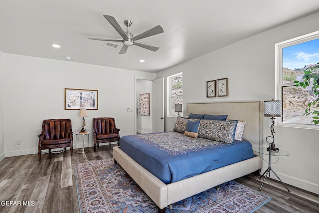 bedroom with multiple windows, ceiling fan, and wood-type flooring