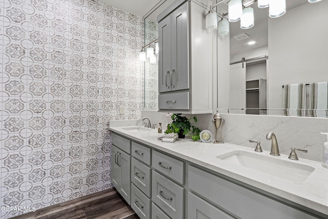 bathroom with vanity, wood-type flooring, and tile walls