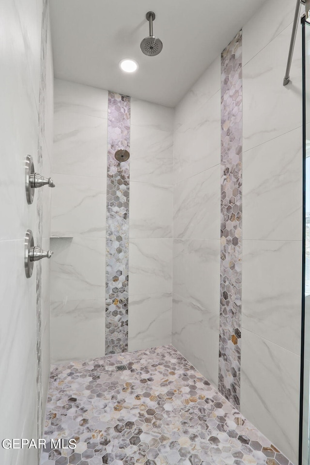 bathroom with a tile shower