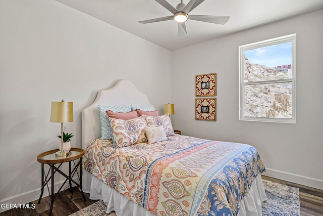 bedroom with ceiling fan and dark hardwood / wood-style flooring