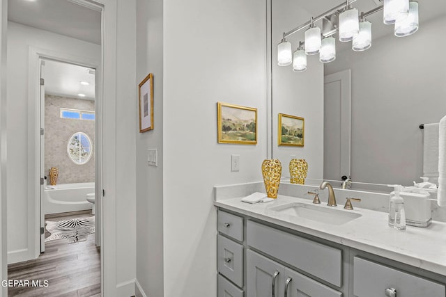 bathroom featuring vanity, shower / bathtub combination, and hardwood / wood-style flooring