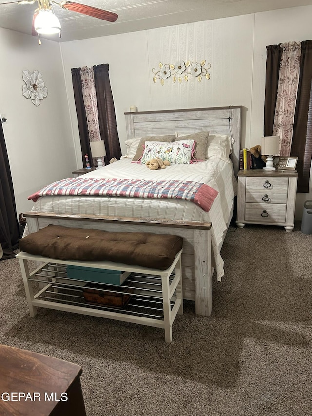 bedroom featuring dark colored carpet and ceiling fan