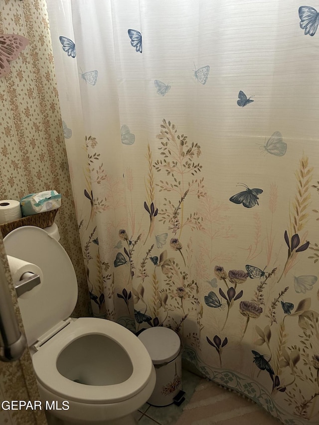 bathroom featuring tile patterned flooring and toilet