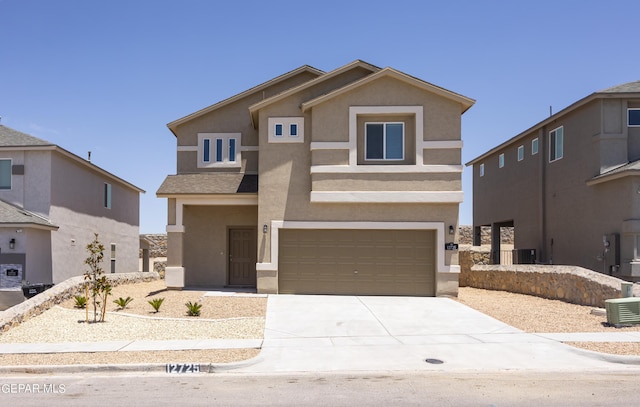 view of front facade with a garage and central air condition unit