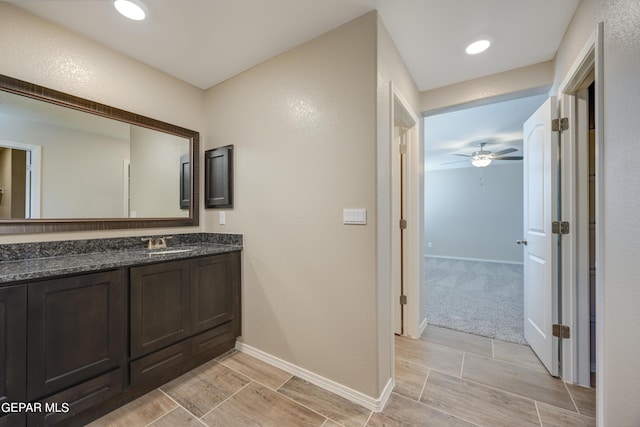 bathroom featuring ceiling fan and vanity