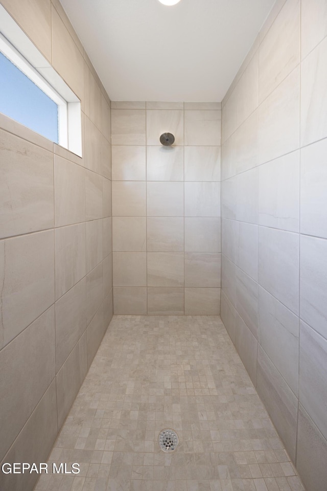 bathroom with tiled shower