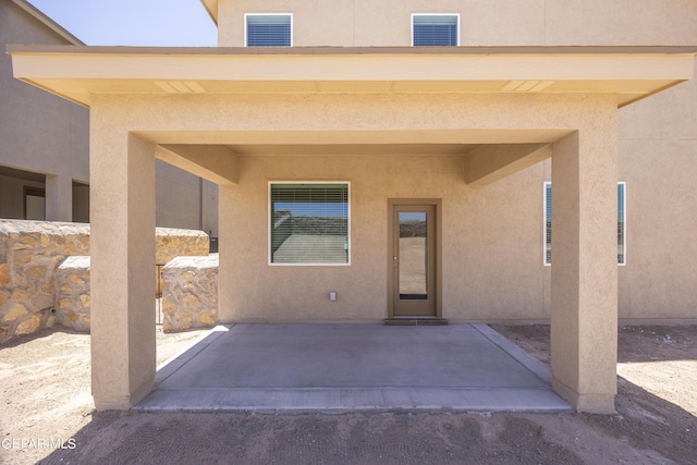 entrance to property featuring a patio area