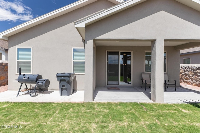 rear view of house featuring a patio area and a lawn