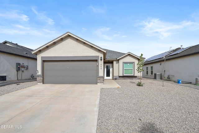 single story home with central AC unit and a garage