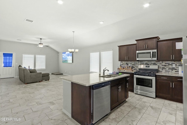 kitchen with decorative backsplash, appliances with stainless steel finishes, ceiling fan with notable chandelier, sink, and lofted ceiling