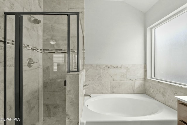 bathroom with plenty of natural light, vanity, and shower with separate bathtub