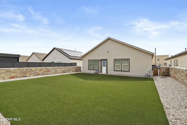 rear view of property featuring a yard