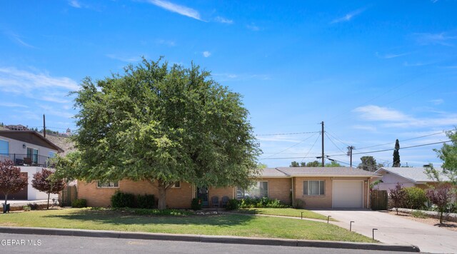 view of front of house with a front yard and a garage