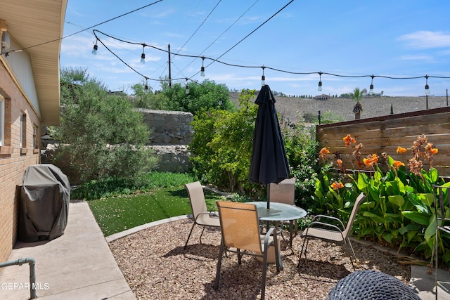 view of patio / terrace with outdoor dining area, a fenced backyard, and area for grilling