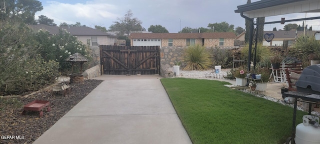 view of gate featuring a yard