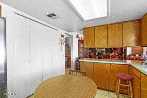 kitchen with kitchen peninsula and light tile patterned floors