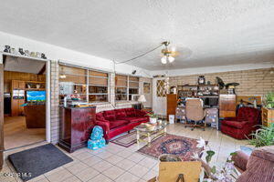 living room with brick wall and tile patterned flooring