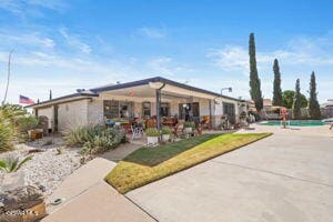 view of property's community featuring a swimming pool and a patio area