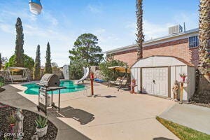 view of pool featuring a patio and a water slide