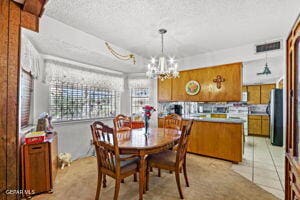 dining area featuring a textured ceiling and a notable chandelier