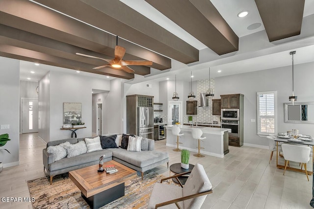 living room featuring ceiling fan, sink, and light hardwood / wood-style flooring