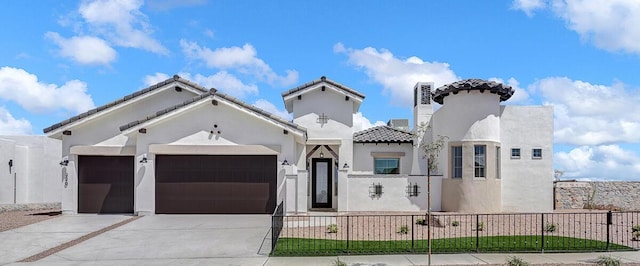 mediterranean / spanish-style home with a garage