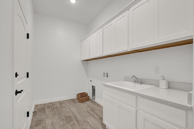 clothes washing area featuring sink, cabinets, washer hookup, light hardwood / wood-style floors, and hookup for an electric dryer