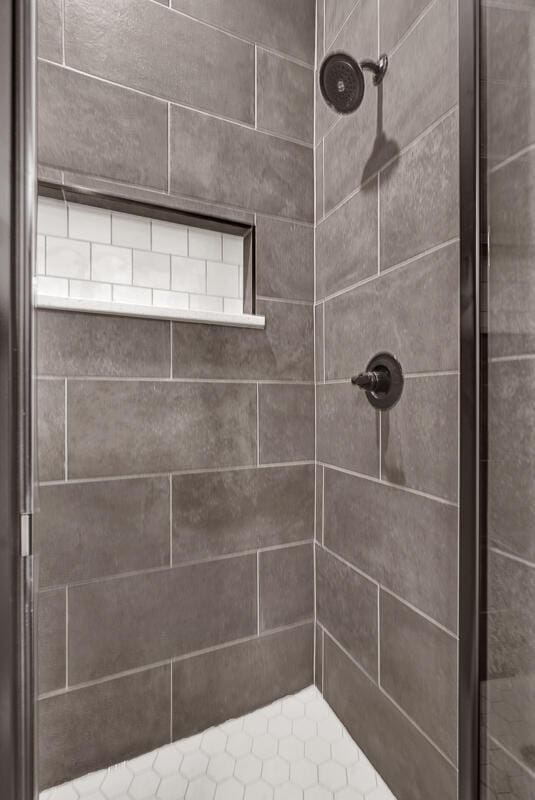 bathroom with tiled shower