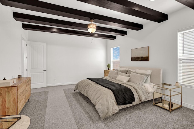 carpeted bedroom with beam ceiling and ceiling fan