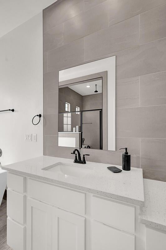 bathroom featuring vanity and a shower