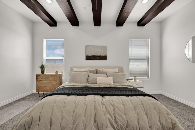 carpeted bedroom with beam ceiling