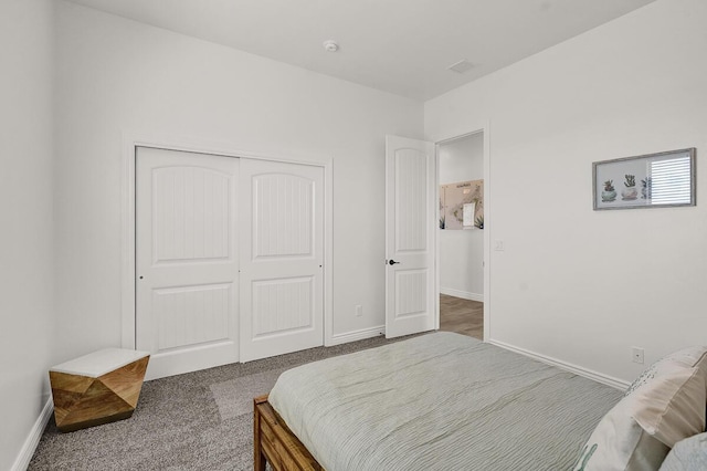 bedroom featuring a closet and dark colored carpet