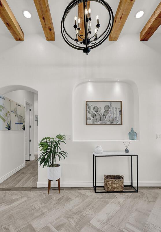 details featuring beamed ceiling, wood-type flooring, and a notable chandelier